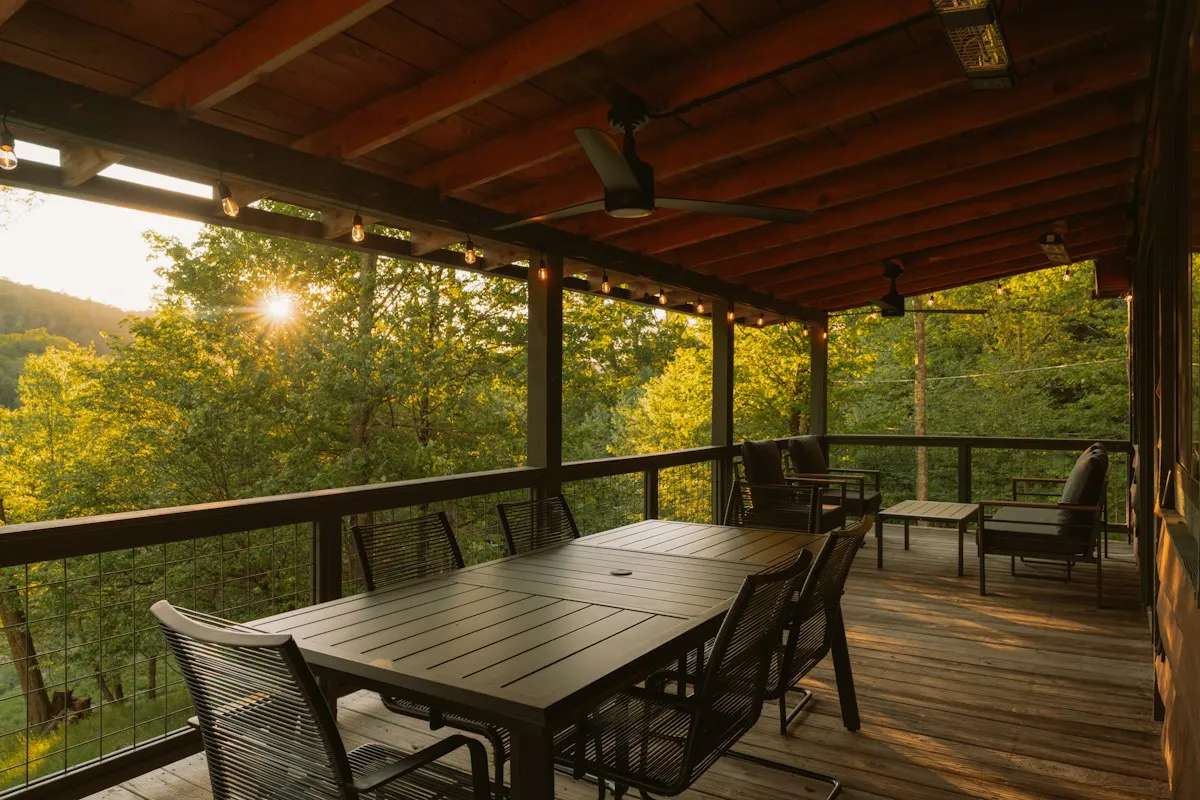 Wooden deck with dining set overlooking a forest
